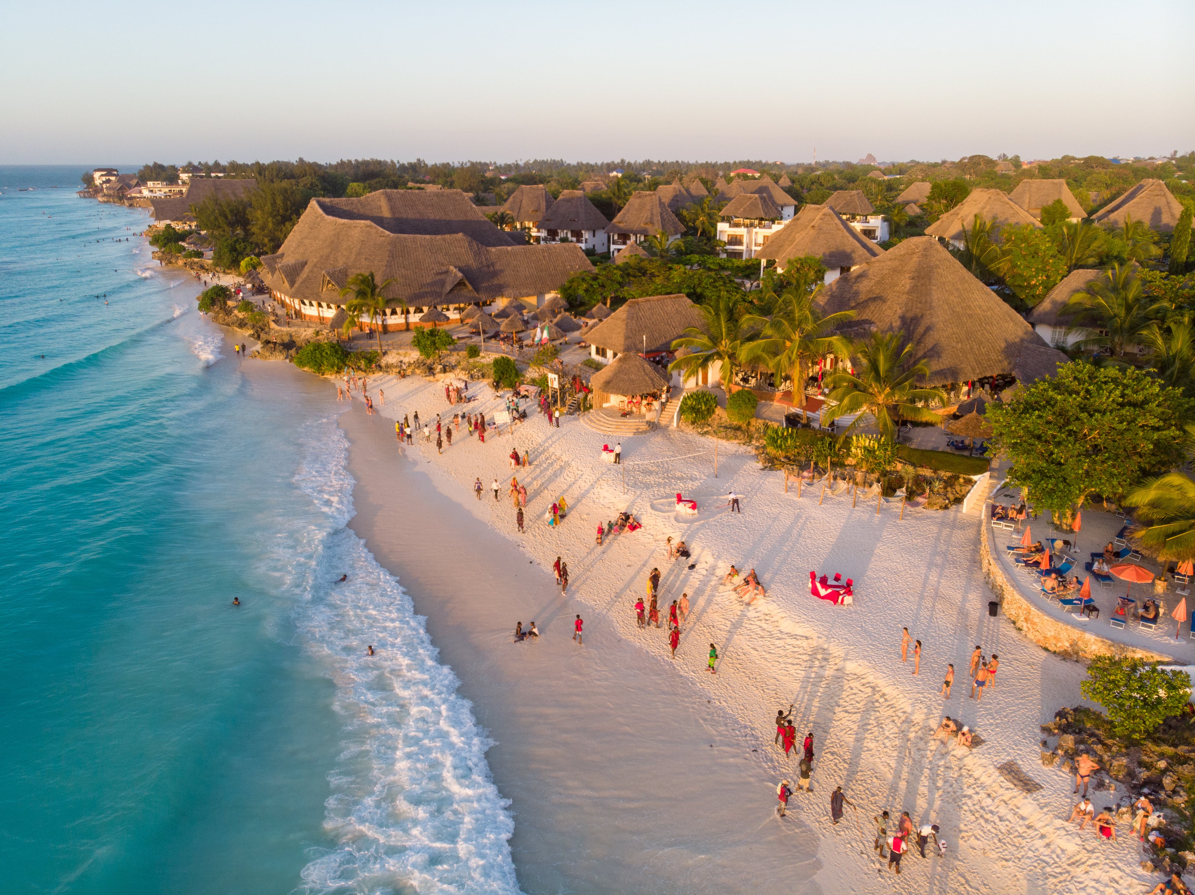 Zanzibar a beautiful sunset with people Walking on the Nungwi beach in Zanzibar in Tanzania